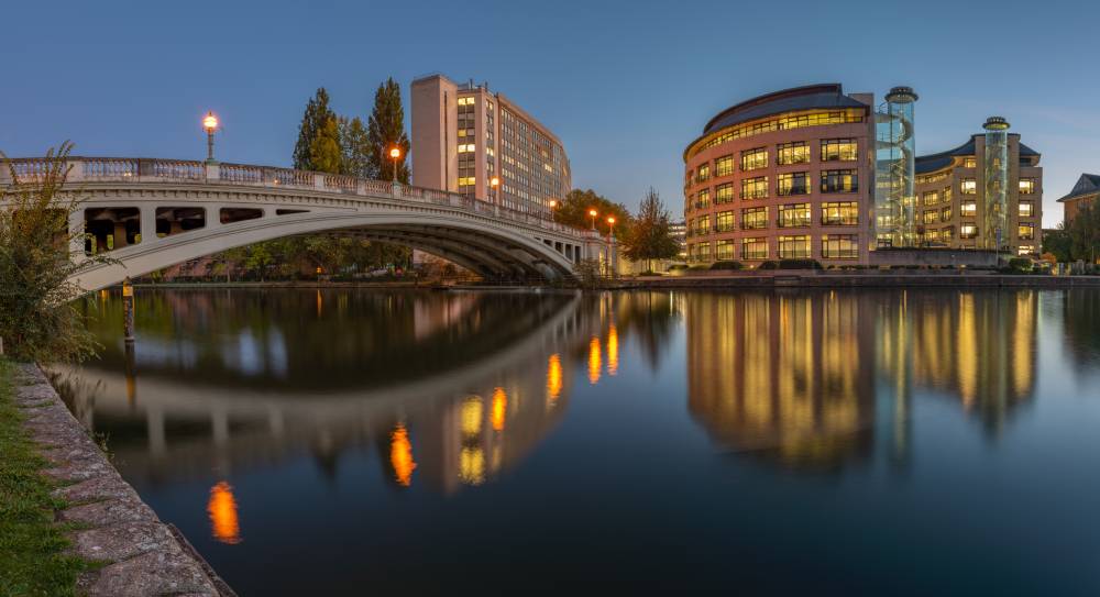 The River Thames and Reading Bridge at dusk, with riverside offices reflected in the water